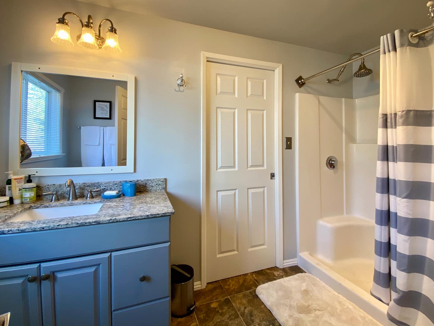 The view from the bathroom from the bedroom. Shampoo, conditioner, and soap are provided